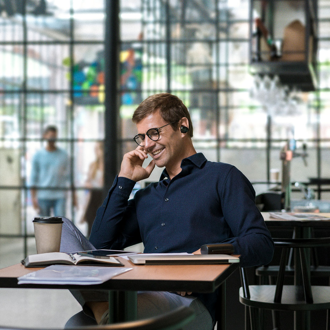 Business man talking into bluetooth headset