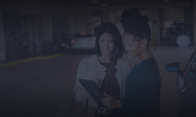 Two women discussing over an iPad