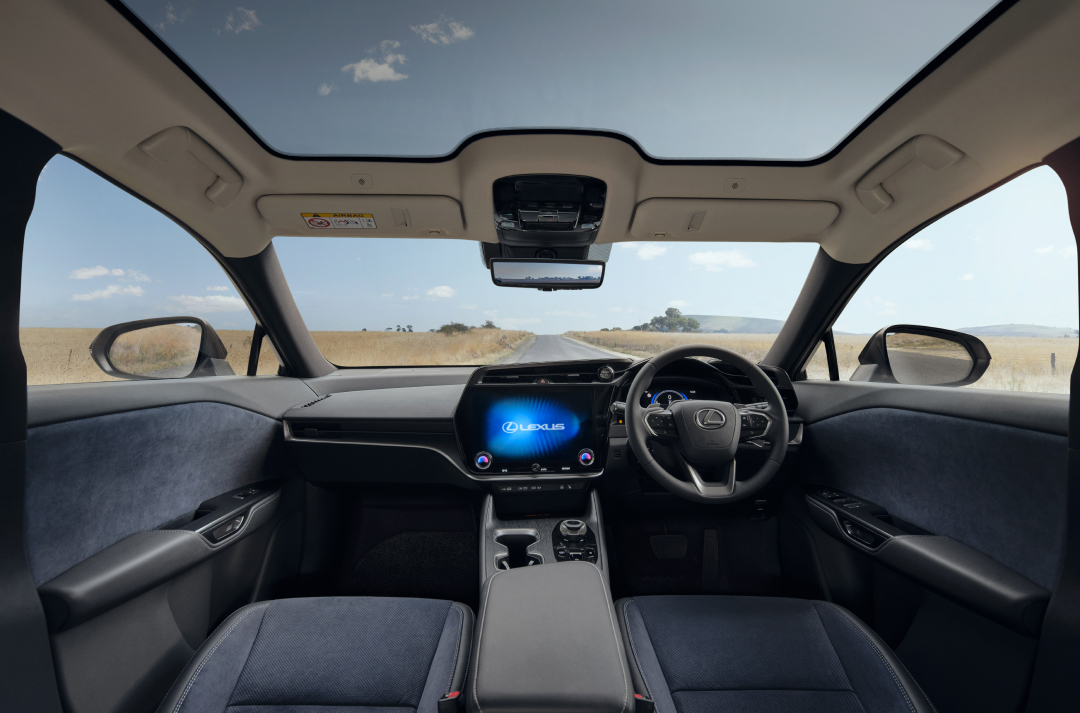 Wide interior view of the Lexus RZ, the sunroof is open.