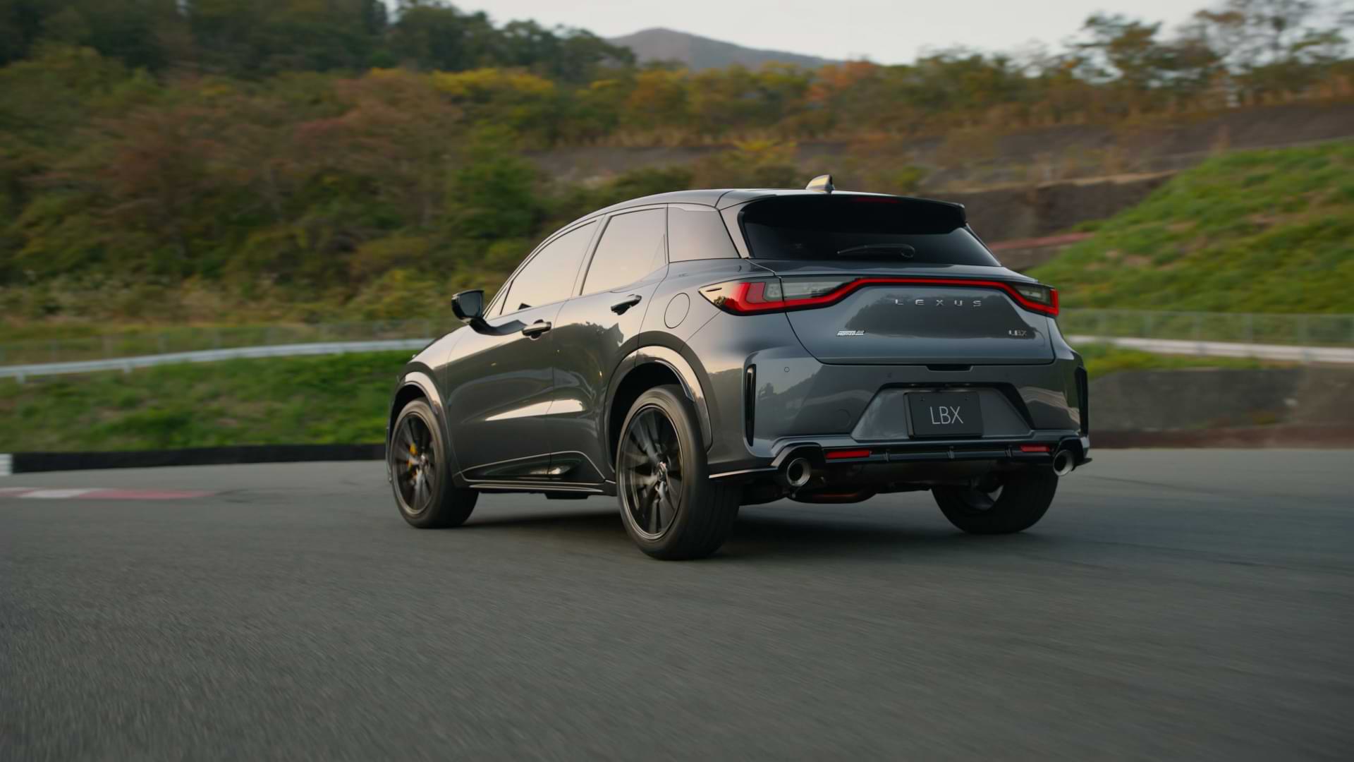 A moving car on the road about to take a turn.