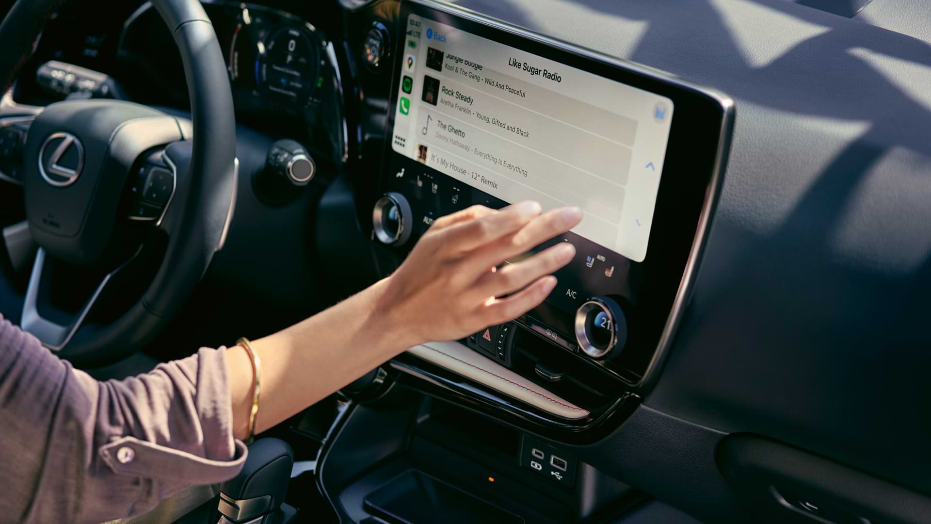 Outstretched hand reaches for multimedia screen