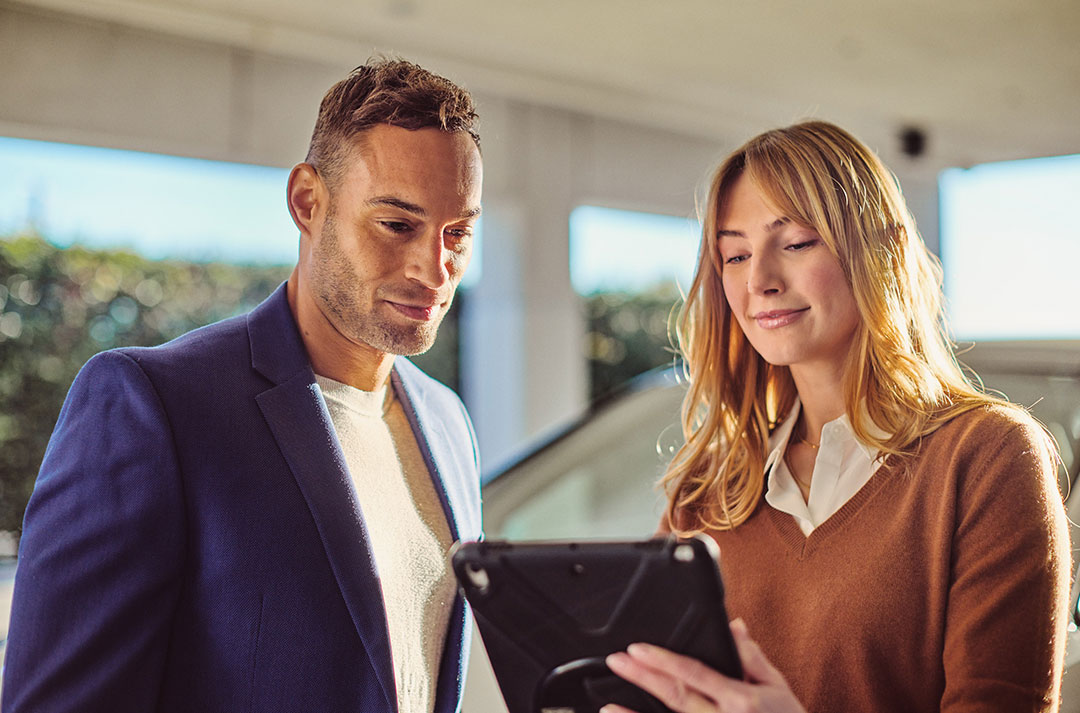 Two people look at a tablet together.