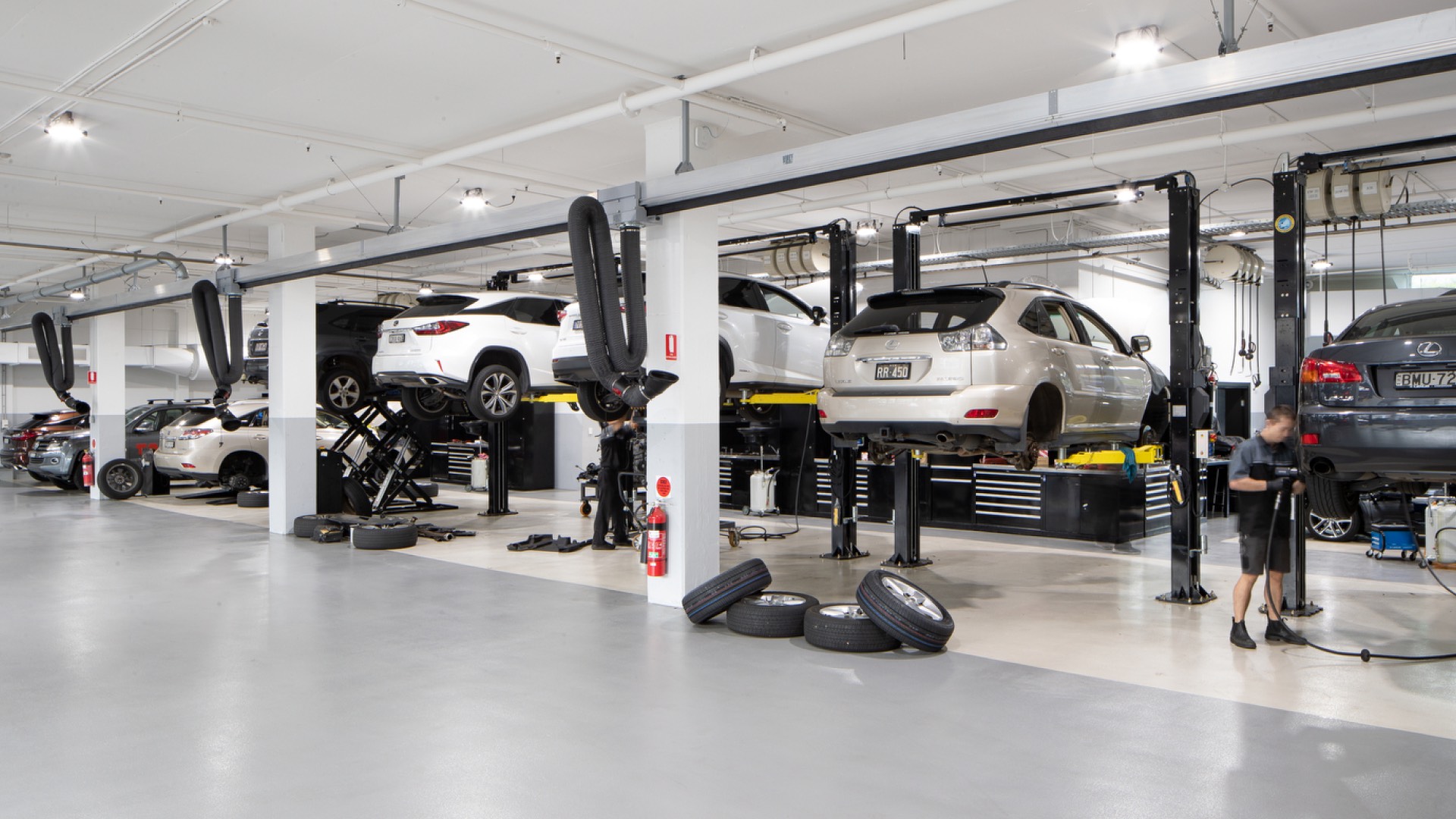 Inside a Lexus Service Centre - a range of vehicles are being serviced by professional Lexus Service Centre Technicians.