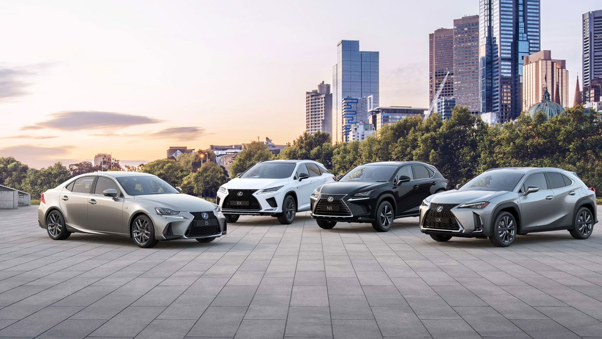 Lexus vehicles parked against a city skyline backdrop