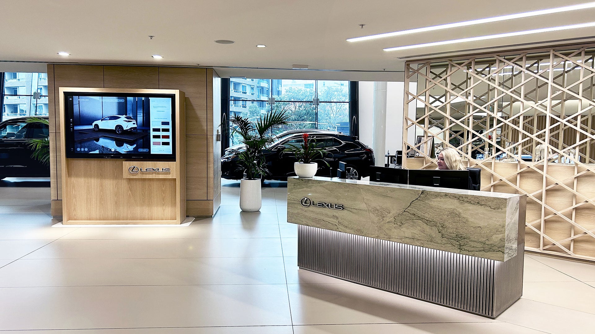 City Lexus reception with a screen and a vehicle in the background