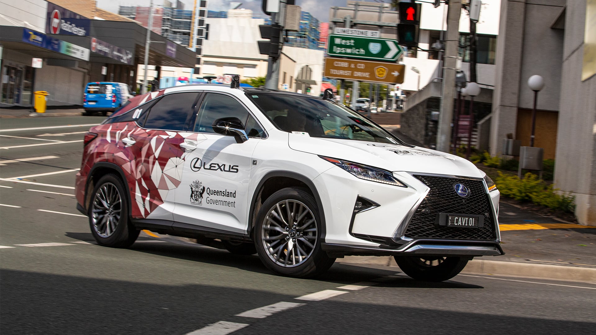 A white Lexus RX with the Queensland Government partnership logo
